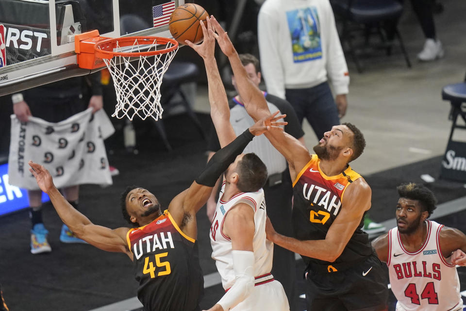 Utah Jazz's Rudy Gobert (27) and Donovan Mitchell (45) defend against Chicago Bulls center Nikola Vucevic, center, in the first half during an NBA basketball game Friday, April 2, 2021, in Salt Lake City. (AP Photo/Rick Bowmer)