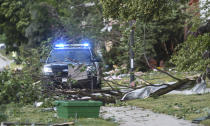 Trees block roads and sidewalks after an overnight tornado touched down in Naperville, Ill. A radar-confirmed tornado swept through communities in heavily populated suburban Chicago, damaging more than 100 homes, toppling trees, knocking out power and causing multiple injuries, officials said, Monday, June 21, 2021. (Paul Valade/Daily Herald via AP)