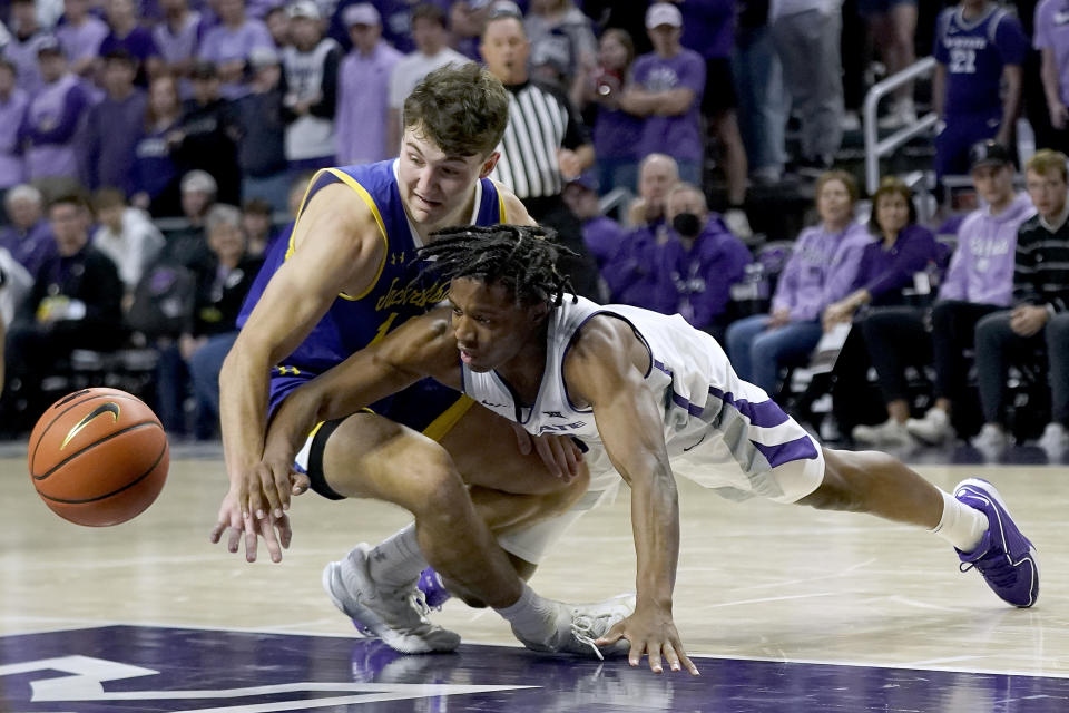 Kansas State guard Darrin Ames, right, and South Dakota State guard Kalen Garry chase a loose ball during the first half of an NCAA college basketball game Monday, Nov. 13, 2023, in Manhattan, Kan. (AP Photo/Charlie Riedel)
