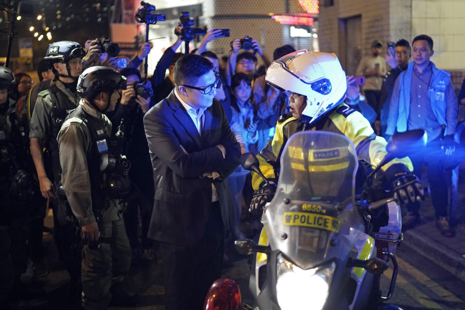 Police Commissioner Chris Tang Ping-keung, center, speaks to a police officer on duty during Christmas Eve in Hong Kong on Tuesday, Dec. 24, 2019. More than six months of protests have stretched the Hong Kong police force. (AP Photo/Kin Cheung) (AP Photo/Kin Cheung)