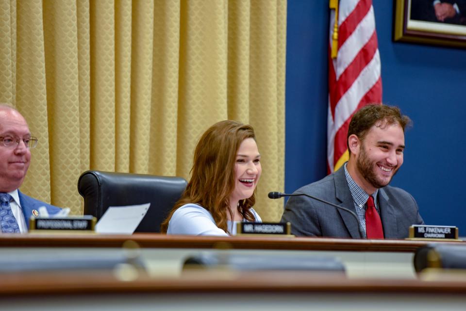 Rep. Abby Finkenauer, as chair of the RATE Subcommittee, jokes with a farmer testifying at her hearing