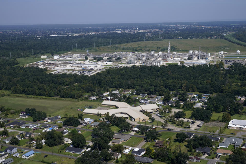 FILE - The Fifth Ward Elementary School and residential neighborhoods sit near the Denka Performance Elastomer Plant, back, in Reserve, La., Sept. 23, 2022. The Biden administration has dropped an investigation into whether Louisiana officials put Black residents living in an industrial stretch of the state at increased cancer risk, despite finding initial evidence of racial discrimination, according to a federal court filing Tuesday, June 27, 2023. (AP Photo/Gerald Herbert, File)