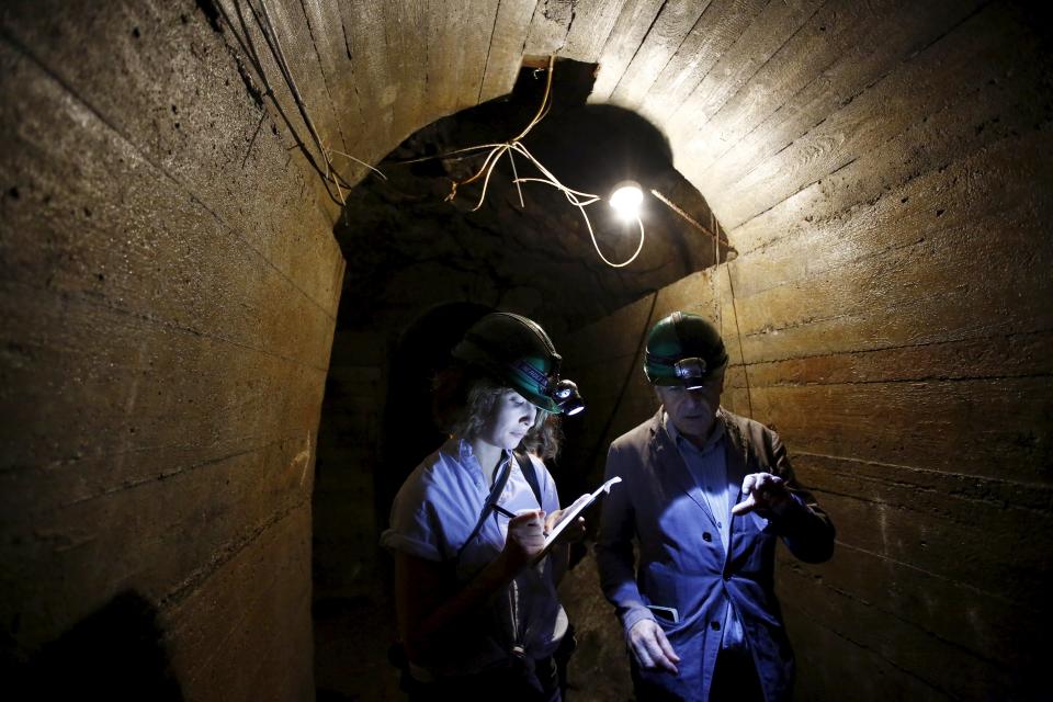 Journalists talk as they visit underground tunnels, which are part of the Nazi Germany "Riese" construction project, under the Ksiaz castle in an area where a Nazi train is believed to be, in Walbrzych, southwestern Poland September 3, 2015. Poland said on Friday it was almost certain it had located the Nazi train rumored to have gone missing near the close of World War Two loaded with guns and jewels. Photographs taken using ground-penetrating radar equipment showed a train more than 100 metres (330 feet) long, the first official confirmation of its existence, Deputy Culture Minister Piotr Zuchowski said. REUTERS/Kacper Pempel