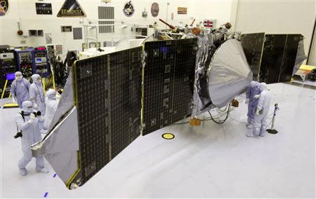 Technicians work on NASA's next Mars-bound spacecraft, the Mars Atmosphere and Volatile Evolution (MAVEN) spacecraft, as it is displayed for the media at the Kennedy Space Center in Cape Canaveral, Florida in this September 27, 2013 file photo. REUTERS/Joe Skipper/files