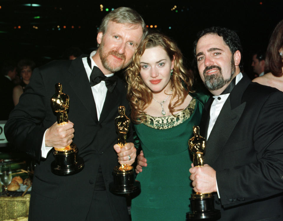 Director James Cameron, Kate Winslet and Titanic producer Jon Landau with 3 of the 11 Oscars which the film won in 1998. (Reuters)