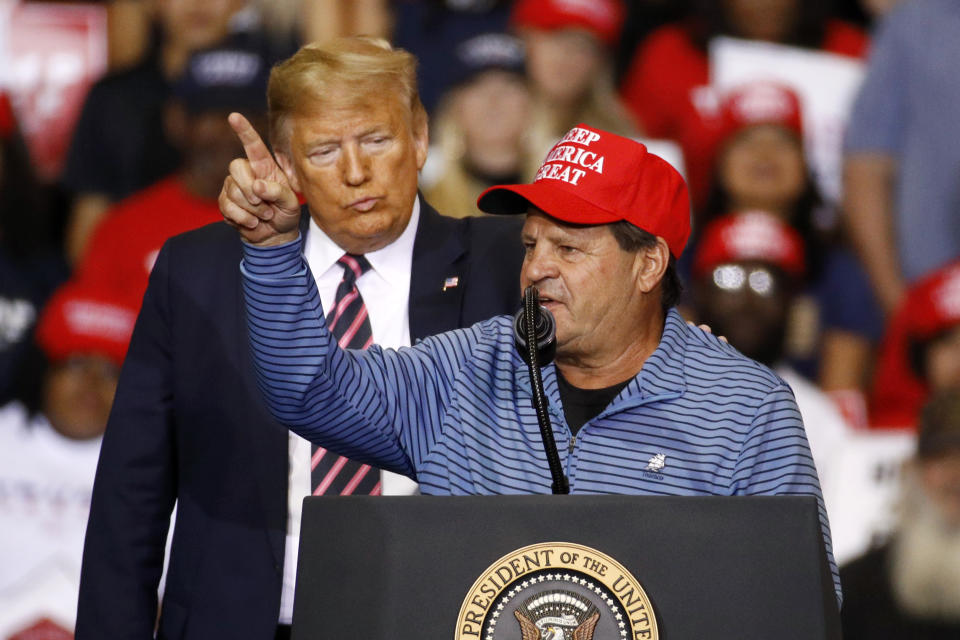President Donald Trump listens as Mike Eruzione, captain of the 1980 U.S men's Olympic hockey team, speaks during a campaign rally, Friday, Feb. 21, 2020, in Las Vegas. (AP Photo/Patrick Semansky)
