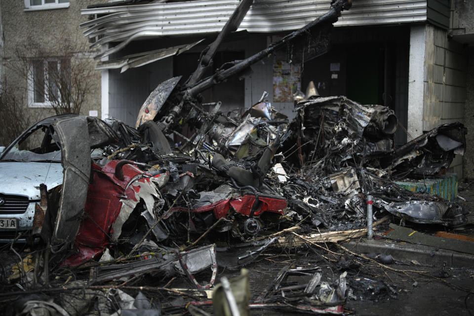 A view of the scene where a helicopter crashed on civil infrastructure in Brovary, on the outskirts of Kyiv, Ukraine, Wednesday, Jan. 18, 2023. The chief of Ukraine's National Police says a helicopter crash in a Kyiv suburb has killed 16 people, including Ukraine's interior minister and two children. He said nine of those killed were aboard the emergency services helicopter. (AP Photo/Daniel Cole)