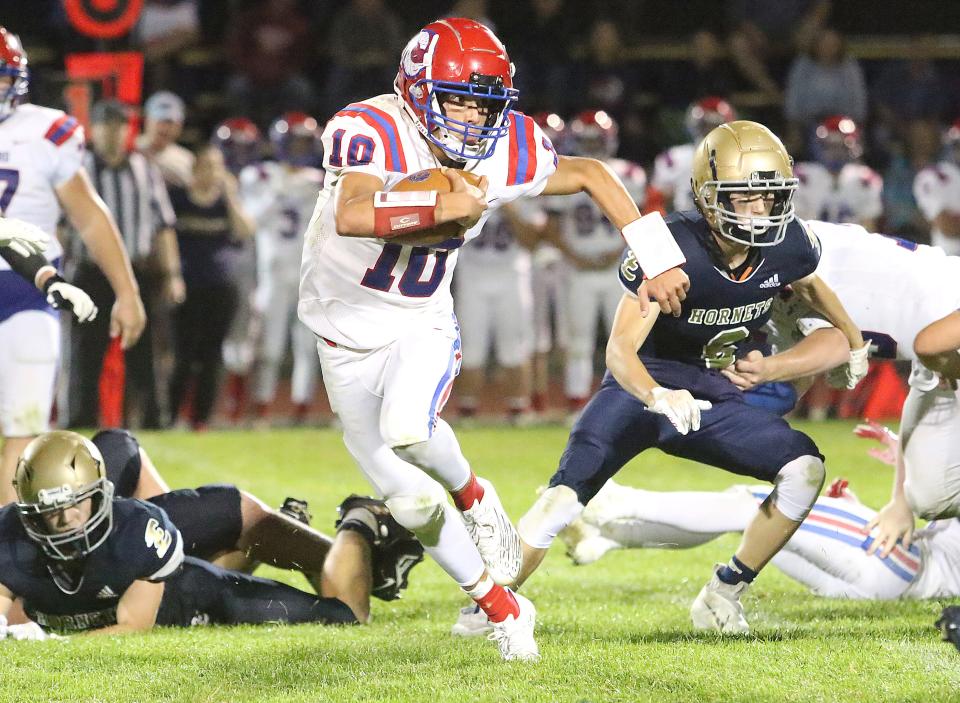 Hartford QB Brayden Trombly finds a hole in the Hornets defense during the Hurricanes 30-21 win over Essex last fall.