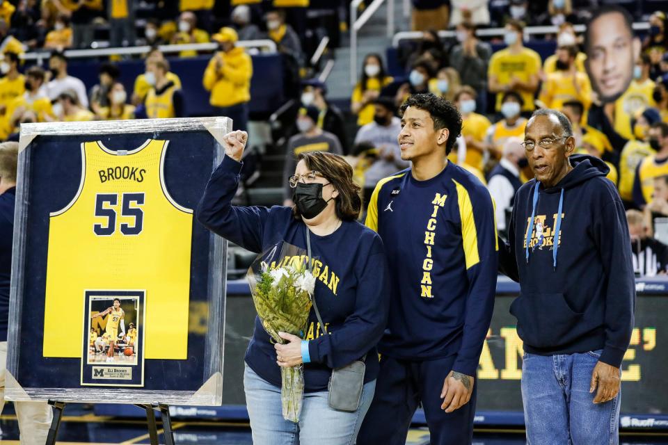 Michigan guard Eli Brooks (55) and his family waves at the fans during senior day before the Iowa game at the Crisler Center in Ann Arbor on Thursday, March 3, 2022.