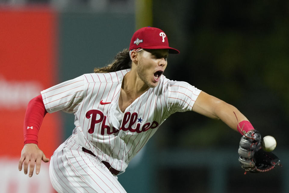 Philadelphia Phillies third baseman Alec Bohm fields a ball before throwing out Miami Marlins' Jacob Stallings at first during the third inning of Game 2 in an NL wild-card baseball playoff series, Wednesday, Oct. 4, 2023, in Philadelphia. (AP Photo/Matt Rourke)