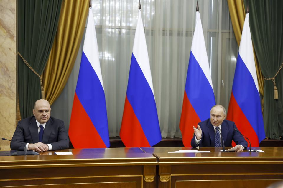Russian President Vladimir Putin, right, and Russian Prime Minister Mikhail Mishustin attend a meeting with Cabinet members in Moscow, Russia, Monday, May 6, 2024. Putin thanked Cabinet ministers for their work ahead of his inauguration Tuesday. (Dmitry Astakhov, Sputnik, Government Pool Photo via AP)