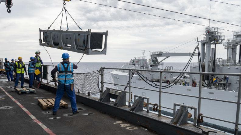 French Aster Surface-to-Air missiles are transferred from the force supply vessel <em>Jacques Chevallier</em> to the aircraft carrier <em>Charles de Gaulle</em>. <em>French Defense Ministry photo</em>