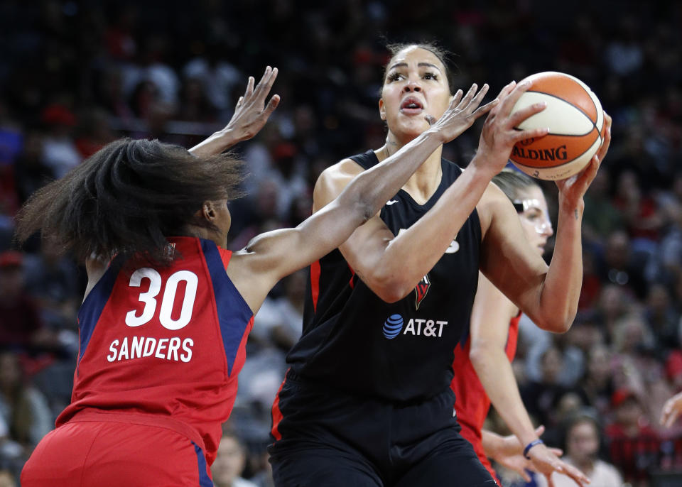 FILE - Las Vegas Aces' Liz Cambage shoots against Washington Mystics' LaToya Sanders during the first half of Game 4 of a WNBA playoff basketball series, Tuesday, Sept. 24, 2019 in Las Vegas. Some of biggest stars in the WNBA could be on the move with free agency set to begin this weekend. Some of the top unrestricted free agents include Sue Bird, Breanna Stewart and Jewell Loyd of Seattle; Liz Cambage of Las Vegas; Sylvia Fowles of Minnesota; Courtney Williams of Atlanta and Courtney Vandersloot, Allie Quigley and Stefanie Dolson of Chicago. (AP Photo/John Locher, File)