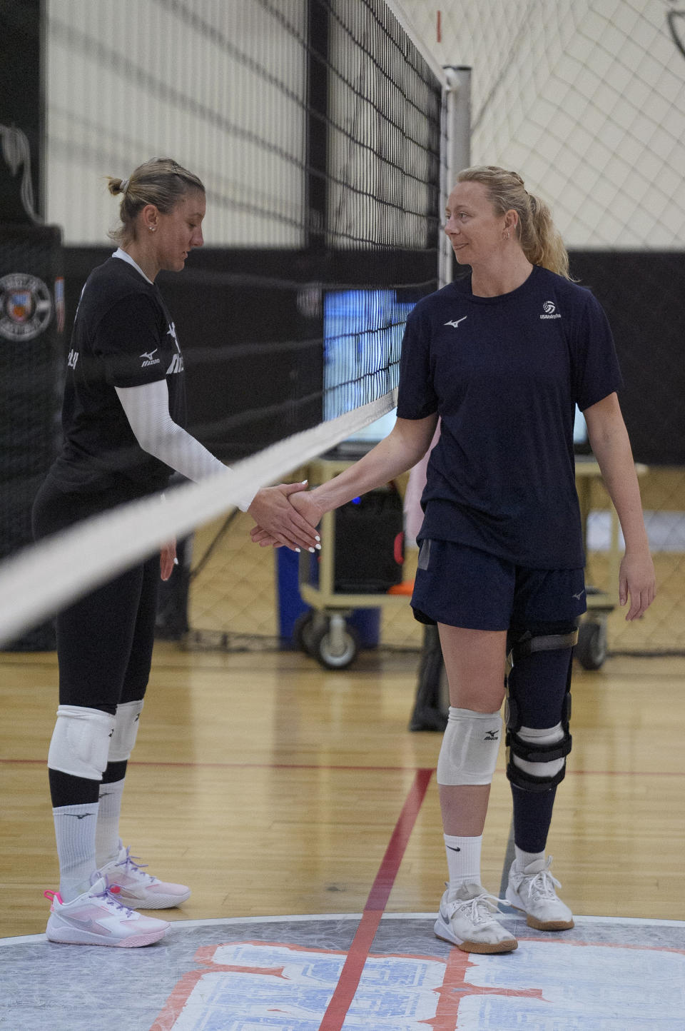 Olympians Jordan Larson, left, and Jordyn Poulter shake hands during the USA Volleyball Spring Training Camp at Open Gym Premier in Anaheim, Calif., on March 12, 2024. (AP Photo/Damian Dovarganes)