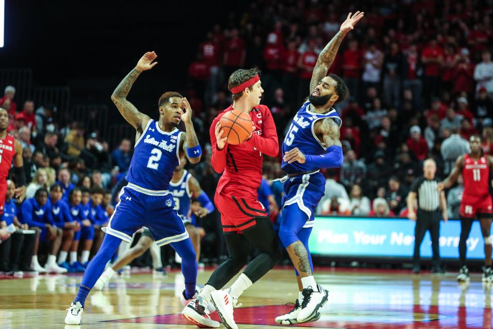 Rutgers Scarlet Knights guard Paul Mulcahy (4) tries to pass over Seton Hall Pirates guard Jamir Harris (15) in the first half at Jersey Mike's Arena.