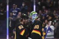 Vancouver Canucks' Sheldon Dries, left, and Spencer Martin celebrate after the Canucks defeated the Seattle Kraken 5-2 in an NHL hockey game Tuesday, April 26, 2022, in Vancouver, British Columbia. (Darryl Dyck/The Canadian Press via AP)