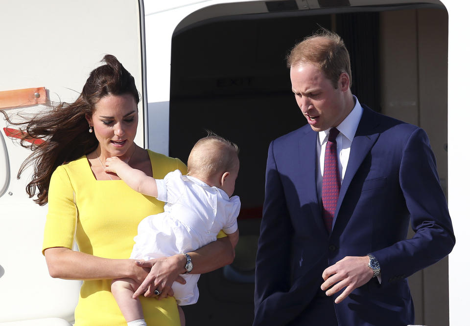 Britain's Prince William with his wife Kate, Duchess of Cambridge, and Prince George, arrives in Sydney Wednesday, April 16, 2014. The royal couple are on a three-week tour of Australia and New Zealand, the first official trip overseas with their son, Prince George. (AP Photo/Rob Griffith)