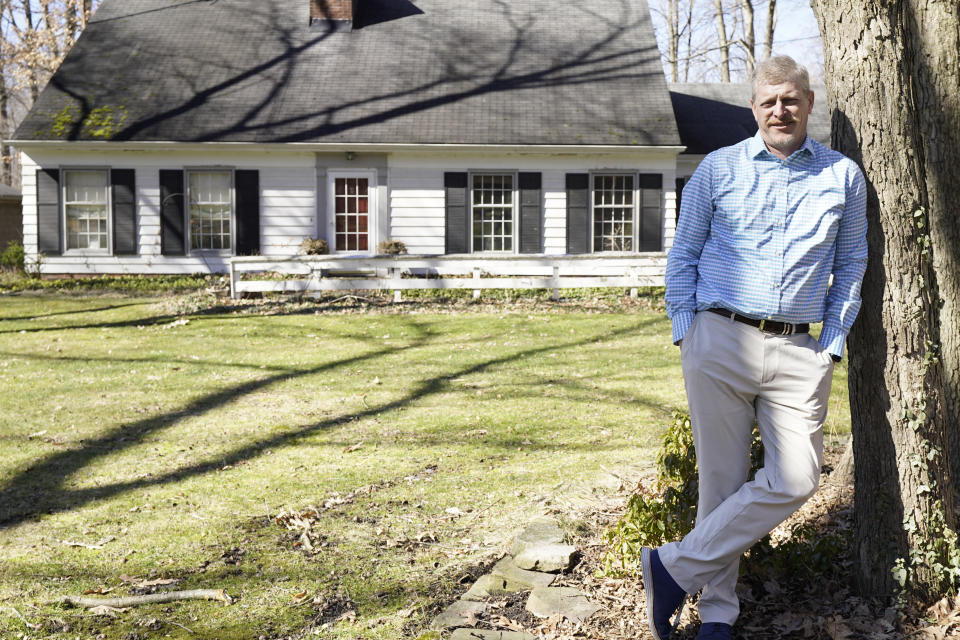 Matt Moorhead poses for a photo in front of his house, Tuesday, March 2, 2021, in Warren, Ohio. When General Motors ended a half-century of building cars in Ohio's blue collar corner, 1,600 workers had to decide whether to accept the automaker's offer to move to another factory. Moorhead went by himself in the summer of 2019 to Lansing where he paid for an apartment on top of his mortgage back in Ohio. After six months of traveling back and forth and "trying to be a dad through a cellphone," his wife convinced him to quit. (AP Photo/Tony Dejak)