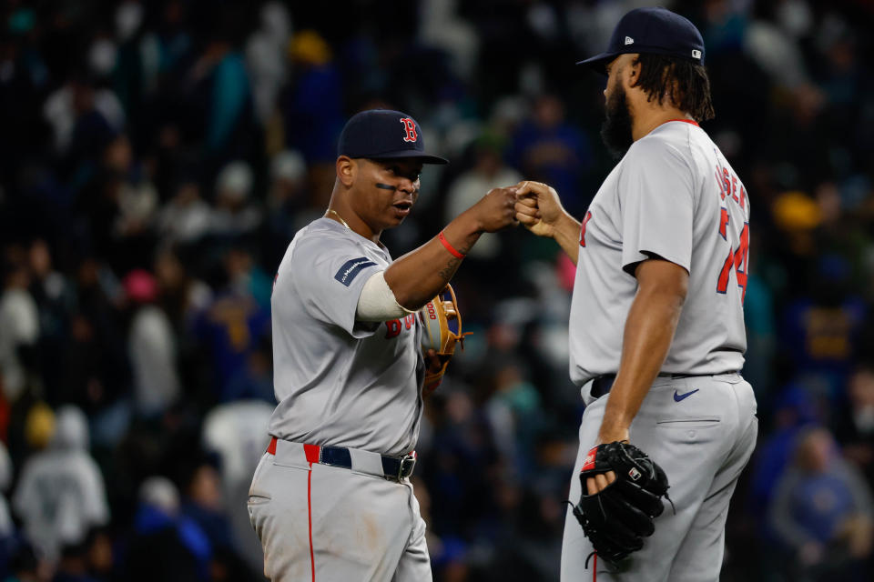 Rafael Devers #11 and Kenley Jansen #74 of the Boston Red Sox 