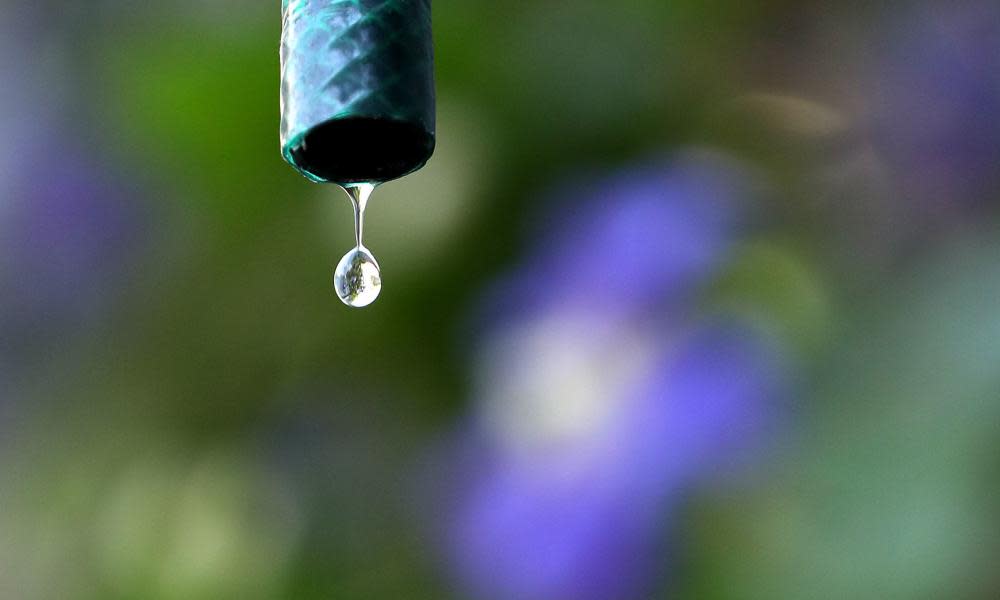 Drops of water fall from a hosepipe