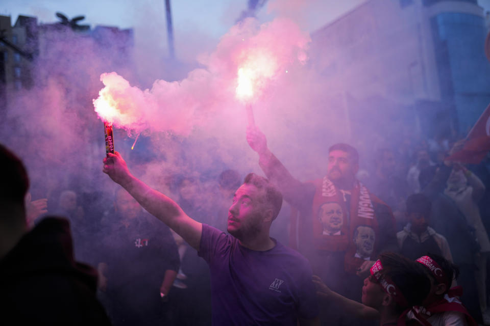 Supporters of President Recep Tayyip Erdogan cheer outside AKP (Justice and Development Party) headquarters in Istanbul, Turkey, Sunday, May 14, 2023. More than 64 million people, including 3.4 million overseas voters, were eligible to vote. (AP Photo/Francisco Seco)