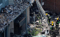 <p>Firefighteres work amongst debris at the base of the charred remnains of the Grenfell Tower block in Kensington, west London, on June 17, 2017, following the June 14 fire at the residential building.<br> (Tolga Akmen/AFP/Getty Images) </p>