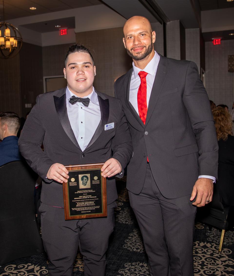 Mt. Healthy senior Kaleb Sherrer (left) won the Tom Potter Memorial Award of Courage Thursday, Feb. 23, 2023 at the Greater Cincinnati Chapter of the National Football Foundation's 56th Annual Scholar-Athlete Banquet in Montgomery, Ohio. He was presented the award by Mt. Healthy head football coach Jordan Stevens.