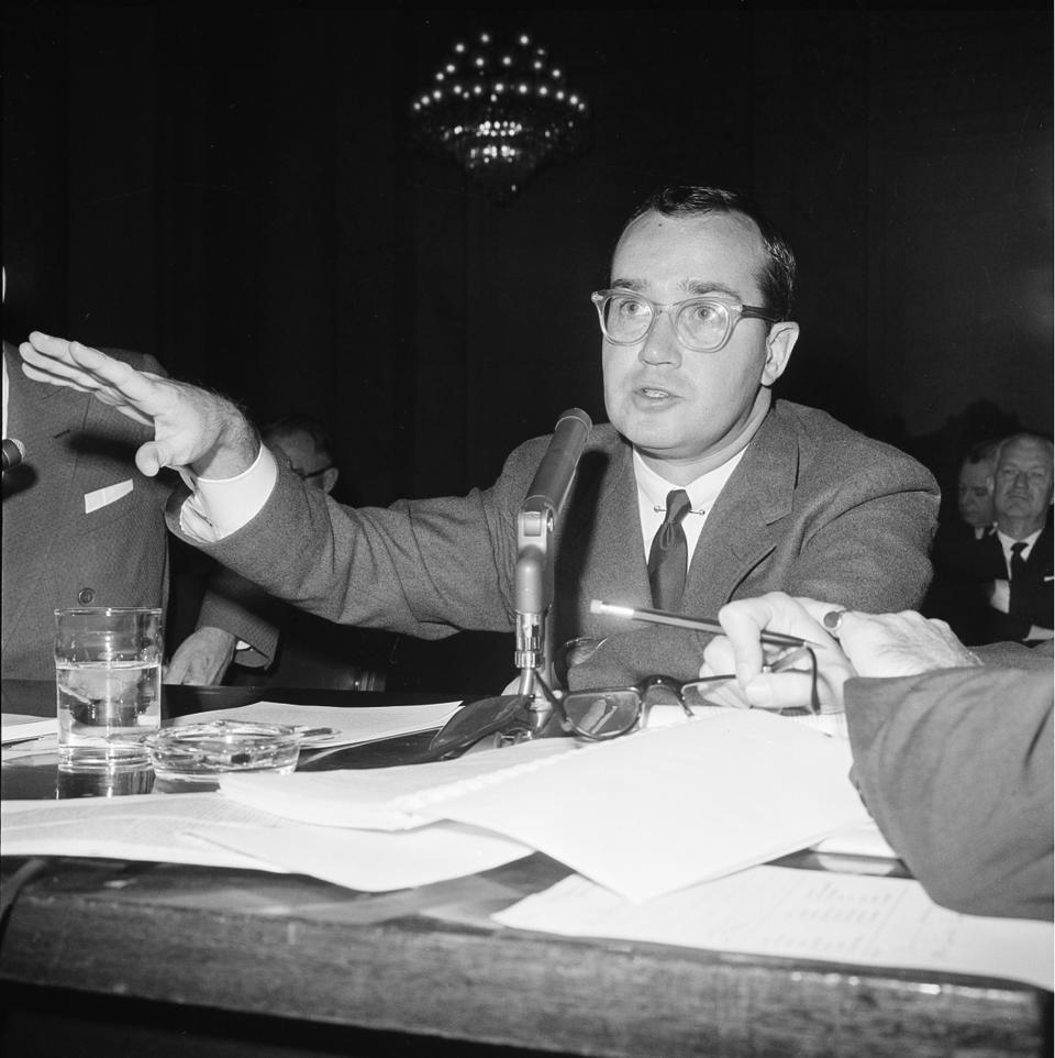 FILE - In this Nov. 9, 1961 file photo, Newton Minow, chairman of the Federal Communications Commission, testifies before the Senate Small Business Subcommittee at a hearing on communication satellites in Washington, D.C. Minow, in his legendary speech on May 9, 1961, said, "I invite you to sit down in front of your television set when your station goes on the air and stay there ... until the station signs off. I can assure you that you will observe a vast wasteland." (AP Photo, file)