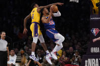 Los Angeles Lakers guard Malik Monk (11) fouls Golden State Warriors forward Otto Porter Jr. (32) during the first half of an NBA basketball game in Los Angeles, Saturday, March 5, 2022. (AP Photo/Ashley Landis)