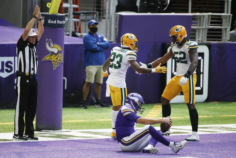 Green Bay Packers cornerback Jaire Alexander (23) celebrates with teammate Rashan Gary (52) after tackling Minnesota Vikings quarterback Kirk Cousins in the end zone for a safety during the first half of an NFL football game, Sunday, Sept. 13, 2020, in Minneapolis. (AP Photo/Bruce Kluckhohn)