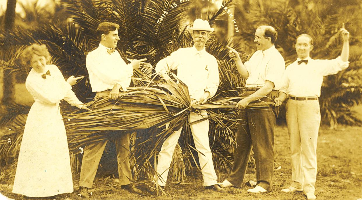 Ward G. Foster, center, is shown with men's haberdashery business leader Emile D. Anthony to his left. The other people in the photo are  unidentified.