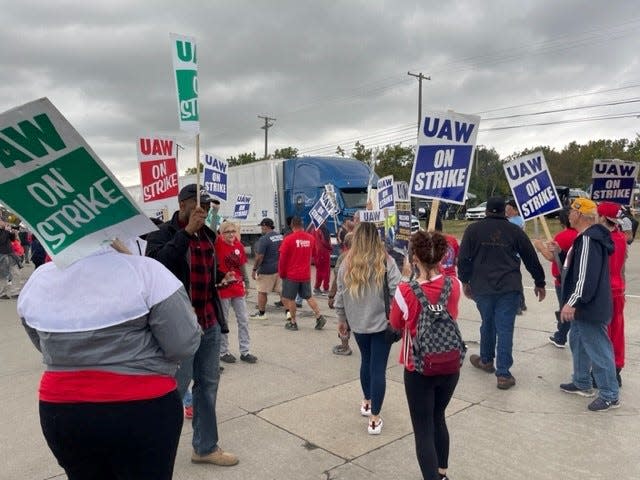 A truck waits for striking workers to step aside before  driving into the Michigan Assembly Plant on Tuesday, Sept. 26, 2023. The Teamsters support the UAW and are not providing truck service during the strike.