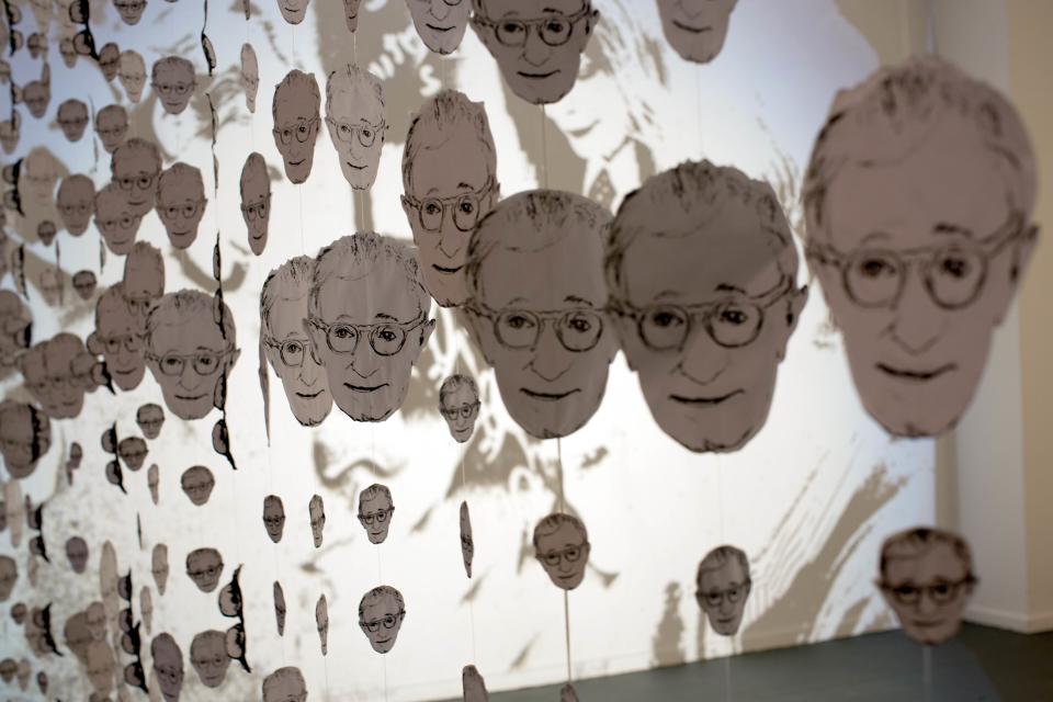 Images in the likeness of U.S. director Woody Allen hang at an art exhibit titled "Queremos tanto a Woody," or "We so love Woody" by Argentine artist Hugo Echarri in Buenos Aires, Argentina, Thursday, Feb. 6, 2014. The exhibit in honor of Allen was inaugurated just days after the artist faced renewed accusations that he molested Dylan Farrow, his then-7-year-old adopted daughter in 1992. (AP Photo/Rodrigo Abd)