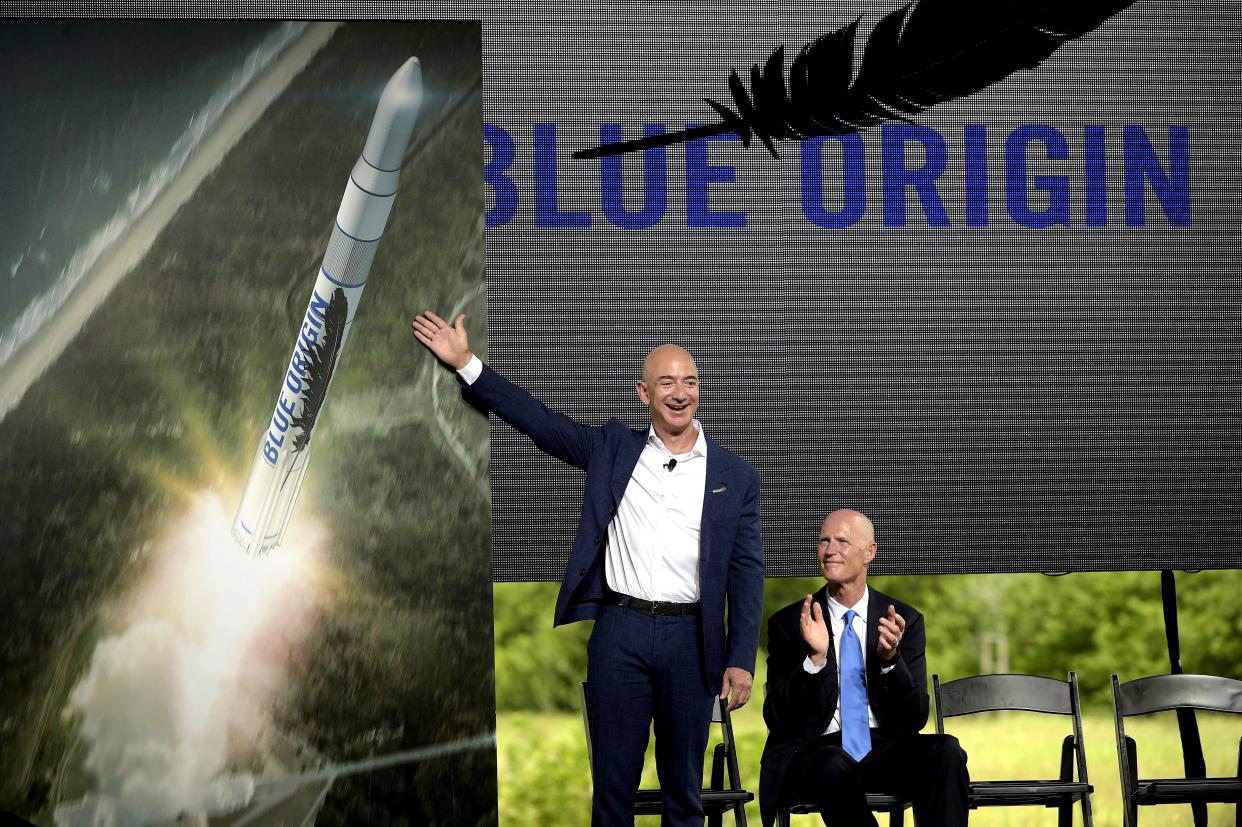 Jeff Bezos unveils a Blue Origin rocket in 2015 alongside then-Florida Gov. Rick Scott.