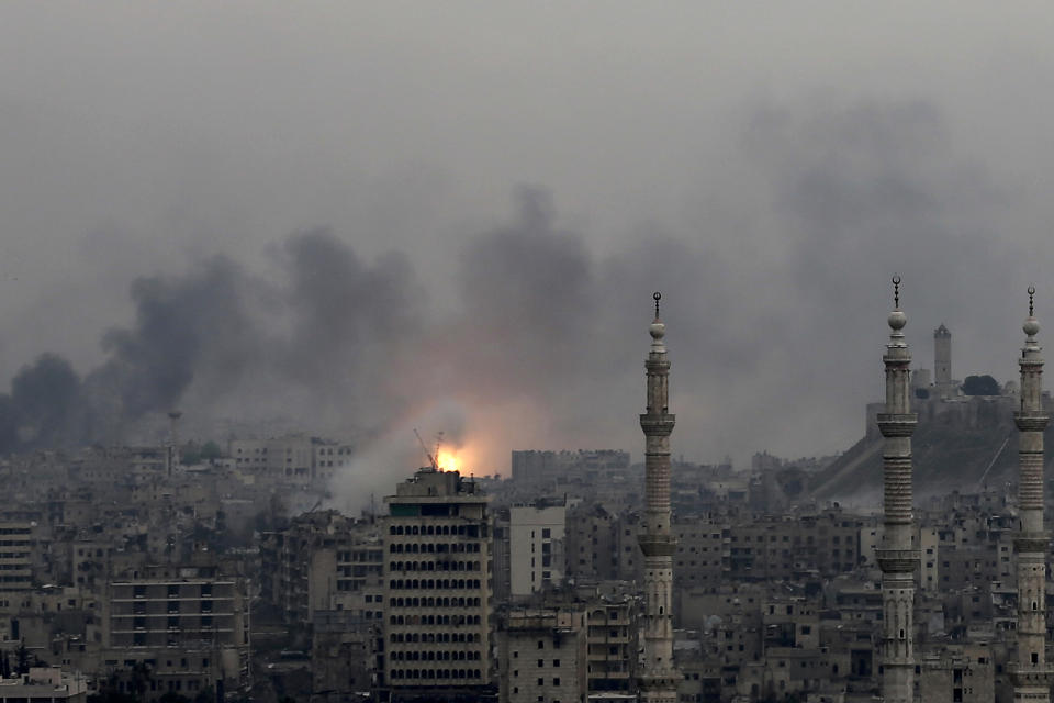 FILE - A ball of fire rises following a Syrian government air strike that hit rebel positions in the eastern neighborhoods of Aleppo, Syria, Dec. 5, 2016. The United Nations said the first 10 years of Syria’s conflict, which began in 2011, killed more than 300,000 civilians. The report released Tuesday, June 28, 2022, by the U.N. Human Rights Office is the highest yet estimate of conflict-related civilian deaths in the country. Syria's conflict began with anti-government protests that broke out in March 2011 demanding democratic reforms following Arab Spring protests across the Middle East. (AP Photo/Hassan Ammar, File)