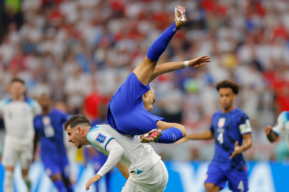 England's midfielder #19 Mason Mount (bottom) and USA's defender #02 Sergino Dest (top) fight for the ball during the Qatar 2022 World Cup Group B football match between England and USA at the Al-Bayt Stadium in Al Khor, north of Doha on November 25, 2022.