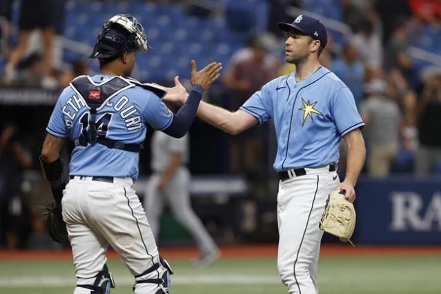 Tampa Bay Rays' Brandon Lowe throws his helmet after striking out