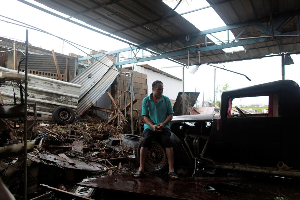 <p>Freddy Guerrero sits amidst the remains of his auto shop, after the island was hit by Hurricane Maria in Toa Baja, Puerto Rico, Oct. 16, 2017. (Photo: Alvin Baez/Reuters) </p>