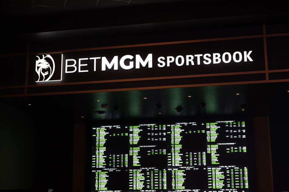 Sports betting odds are constantly updated on a large LED board at BetMGM.