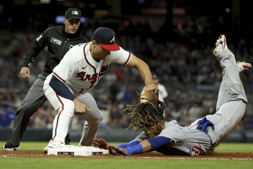 Atlanta Braves first baseman Matt Olson tags out Chicago Cubs' Michael Hermosillo at first base for a double play during the eighth inning of a baseball game at Truist Park Tuesday, April 26, 2022, in Atlanta. (Jason Getz/Atlanta Journal-Constitution via AP)