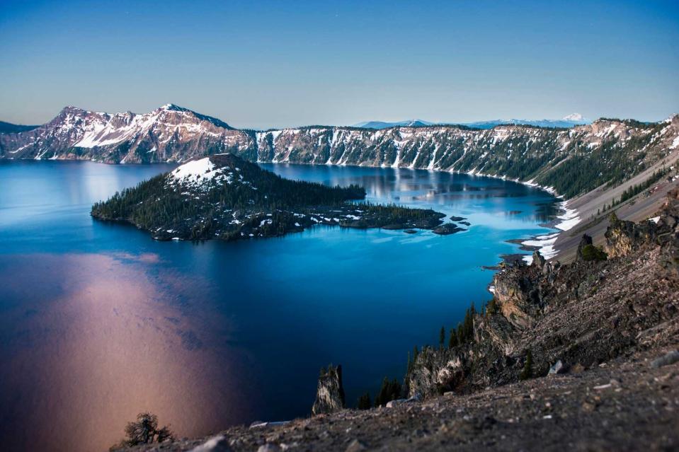 Scenic view of Wizard Island amidst Crater Lake against sky