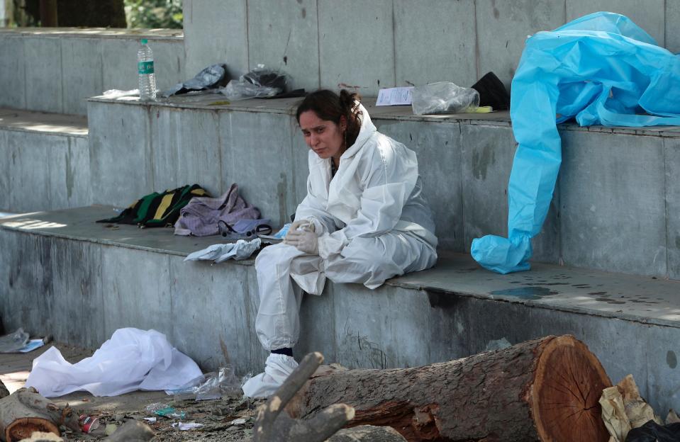 A relative of a person who died of COVID-19 mourns at a crematorium in Jammu, in Jammu, India, Friday, April 30, 2021.