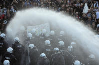<p>Police and demonstrators are sprayed by a water cannon during a protest against the G-20 summit in Hamburg, northern Germany, Thursday, July 6, 2017. (Photo: Markus Schreiber/AP) </p>