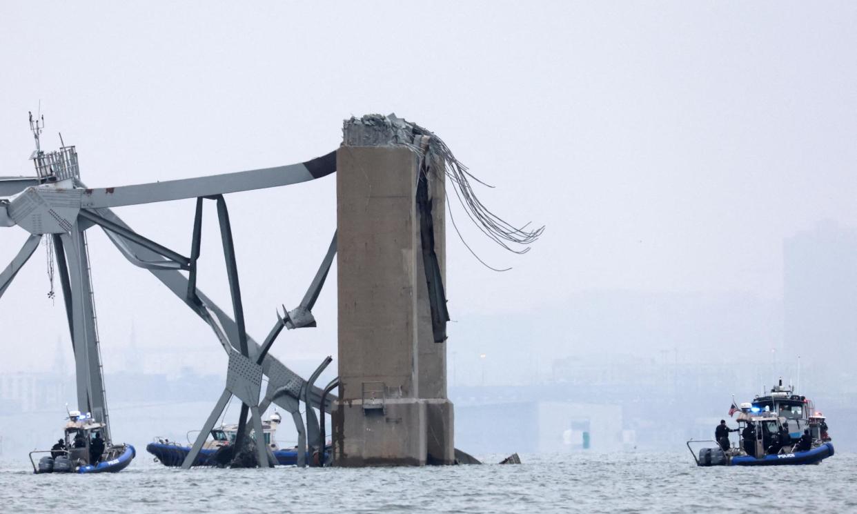 <span>Emergency boats work near the collapsed section of the Francis Scott Key Bridge on Wednesday.</span><span>Photograph: Mike Segar/Reuters</span>