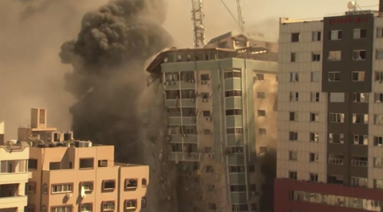 A building housing various international media, including The Associated Press, collapses after an Israeli airstrike on Saturday, May 15, 2021, in Gaza City. The airstrike Saturday came roughly an hour after the Israeli military ordered people to evacuate the building. There was no immediate explanation for why the building was targeted. The building housed The Associated Press, Al-Jazeera and a number of offices and apartments.