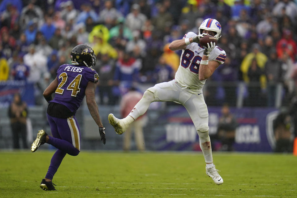 Buffalo Bills tight end Dawson Knox (88) makes a catch as he is defended by Baltimore Ravens cornerback Marcus Peters (24) in the second half of an NFL football game Sunday, Oct. 2, 2022, in Baltimore. (AP Photo/Julio Cortez)