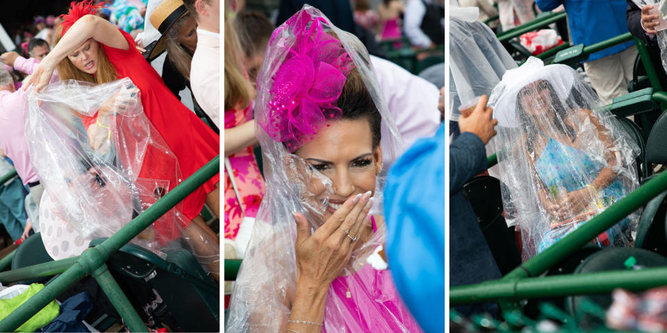 Women cover themselves in plastic ponchos.