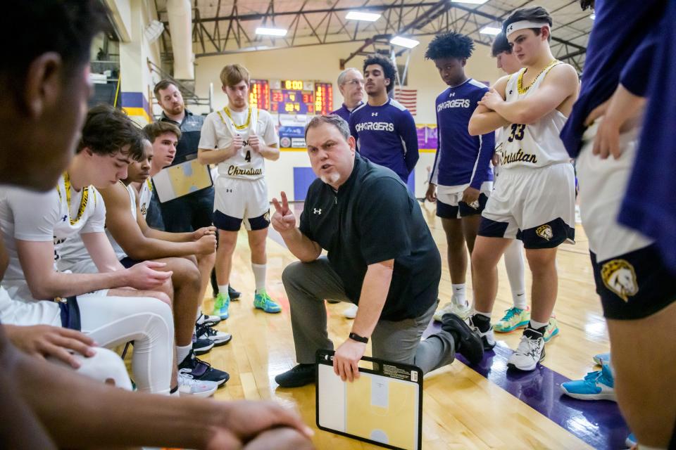 Peoria Christian head coach Jason Persinger talks with his team late in the second half against Illini Bluffs on Friday, Jan. 20, 2023 at Peoria Christian High School. The Tigers defeated the Crusaders 45-35.