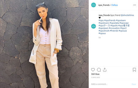 Elicena Andrada, a model from Spain whose biography lists she was crowned Miss America Latino Del Mundo in 2017, holds an IQOS "heated toballo" device, made by Philip Morris International in an Instagram post on an account called @iqos_friends, in a post from May 12, 2019. @iqos_friends/Social Media via REUTERS