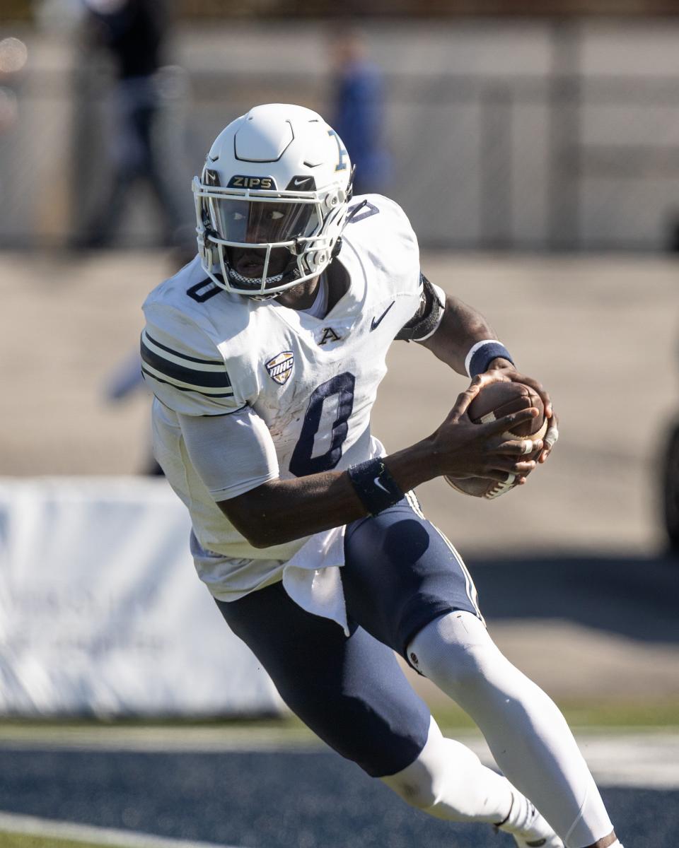 Akron quarterback DJ Irons scrambles with the ball during Saturday’s football game against the Golden Flashes at Kent State University’s Dix Stadium.
